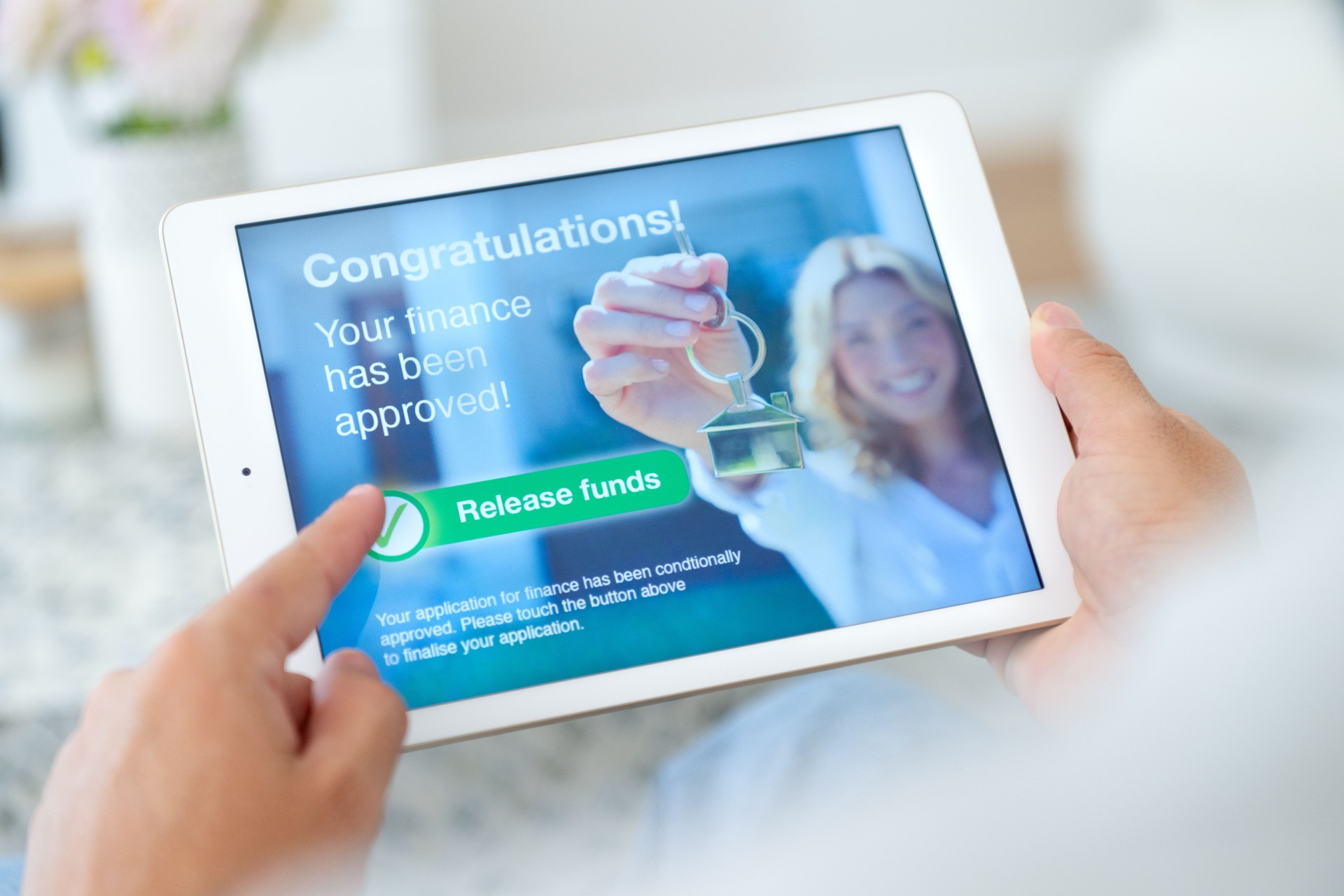 Man holding a digital with loan application approval.