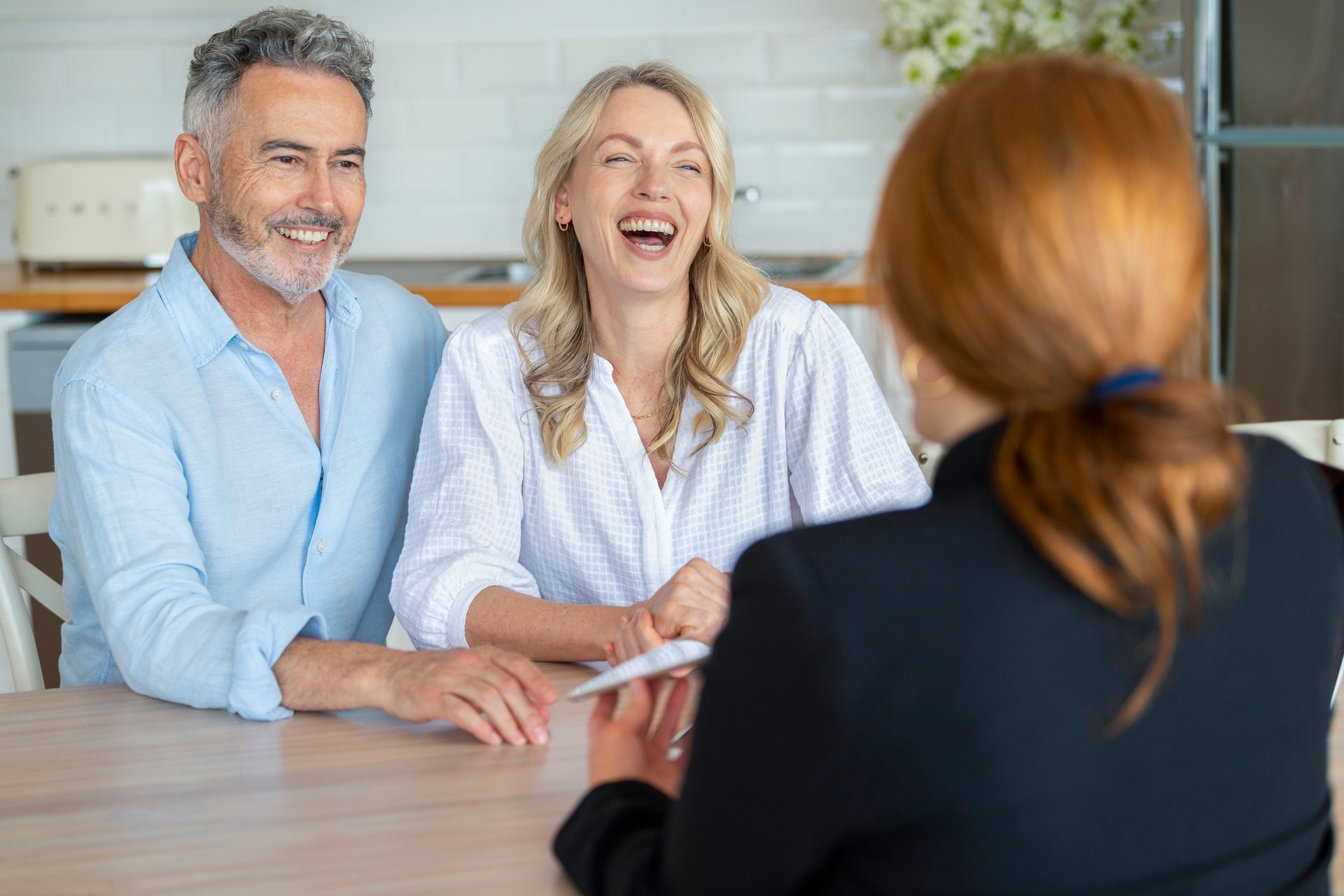 Happy mature couple meeting investments and financial advisor at home